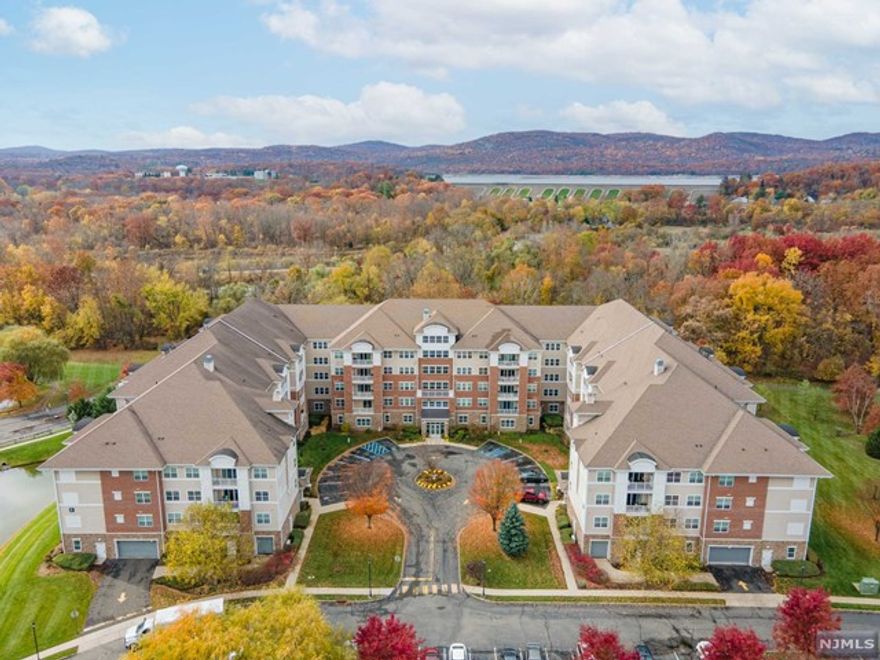 For more information on this home please contact Dan Brozyna- 201-679-2857. What a rare find - a corner unit with fabulous views and no units above you! Step into this glistening 1768 sq ft unit with hardwood floored foyer. The formal dining room with gorgeous crown molding is steps away from the den. The primary bedroom with walk in closet, extra closets and primary bathroom with double sink and shower. The sunlit living room opens up to the balcony that oversees the clubhouse, entrance, tennis courts and ponds. The large kitchen has tile floors, backsplash, Corian tops along with a nice breakfast nook. The laundry/utilities are strategically located. An additional large bedroom, full bath and storage closet complete this fabulous unit. Make sure to visit the clubhouse with indoor and outdoor pool, community center, exercise room and so much more. Make the Wanaque Reserve your home!