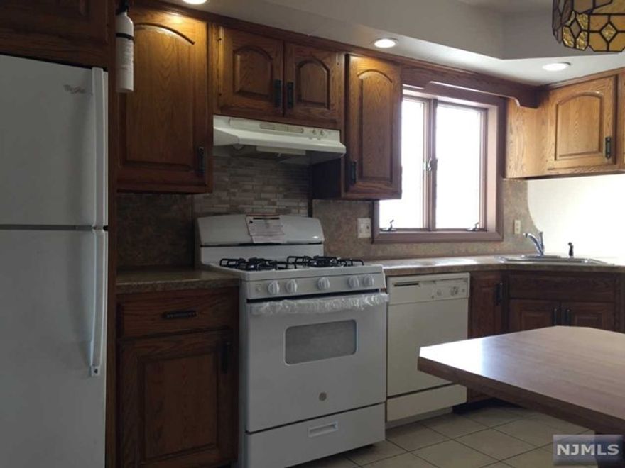 Come view this 3 bedroom, 2 bath Second Floor Unit with an Eat in Kitchen, complete with a Dishwasher, Small Microwave and a New Range. The unit also has a large Bright Dining Room with tile floor. The Sliding Glass Door in the Spacious Living Room leads to the Large Covered Terrace that Overlooks the Backyard which the tenant may use. Its Convenient location is a few minute drive to the train station and across the street from a laundry mat.