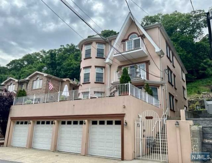 Spectacular top floor unit features beautiful open floor plan and approx. 2000 square feet of living space. Huge living room with gas fireplace and baloney, Gorgeous granite kitchen flowing into a dining area with plenty of natural light. Master bedroom with private bathroom suite and two additional large bedrooms. Laundry and full bathroom complete this impeccable space. Keep your cars in an attached tandem garage perfectly fitting two large vehicles Walk to River Road, shops and NYC transportation. Owner hold NJ Real Estate license