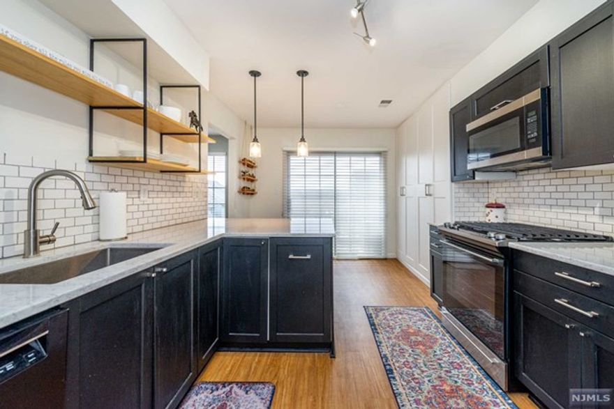 Spectacular end unit, multi level living! Completely remodel finished in 2020- modern, relaxing & low maintenance. Open & bright floorplan; tons of natural light w/oversized windows & 2 sliders that lead to balconies. A true Chef's oasis -Updated kitchen w/newer appliances, marble style quartz countertops, under-mount deep SS single bowl sink, slide-in gas range, low decibel SS tub dishwasher, soft close drawers, bfast bar & pantry! Formal dining area. Large, yet cozy LR w/WB fireplace. New flooring w/acoustic barrier. 1st floor bdrm & full bath w/new stall shower, thermostatic shower controls, modern vessel sink, faucet & vanity. Upstairs, the master boasts a built in reading nook & tons of closets & attic storage. The master bath is truly a relaxing escape! Offers all the same upgrades as the 1st floor bath mentioned + expansive countertop space, solid surface mold/mildew resistant shower, a garden tub, a quiet exhaust fan w/timer control & Toto toilet. Freshly painted.