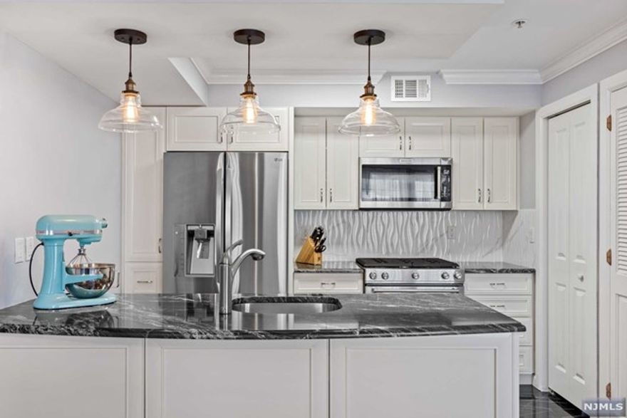 Rare to market one bedroom, plus den condominium at Sokol Hall. No detail was overlooked in this recently renovated corner unit. You are welcomed by a large entry foyer with built-in closet, leading to the spacious den and hallway half bathroom. The sunlit open concept floor plan showcases a large living and dining room combo with gorgeous eat-in kitchen, featuring granite countertops, new stainless steel appliances, and large pantry. The expansive primary bedroom features a custom walk-in closet and full ensuite bath. Additional features include, new oak flooring throughout, newer water heater, central A/C, custom window shades and industrial grade washer/dryer. Sokol Hall is a boutique elevator building offering the convenience of deeded parking and virtual doorman entry. Prime location, less than 6 miles to Port Authority Bus Terminal and only two blocks from scenic Boulevard East.