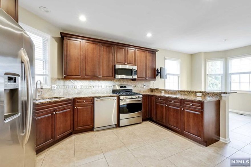 Welcome Home! Move In Ready, Upgraded Gramercy Model For The Most Discerning Buyer! Very Tastefully Done. Open, Airy, Sun Drenched, and Easy Living Would Describe This Townhome. An Elevator Provides Easy Access To All Floors, A Great Option For Your Convenience. Three Bedrooms, One Of Which Is A Large Primary Bedroom En Suite, With 2 Customized Walk In Closets, A Generous Sized Loft, A Full Bath, And Laundry Room Complete The 2nd Floor. The 1st Floor Features A Gourmet Custom Kitchen With A Beautiful Tile Backsplash & Stainless Steel Appliances. Other Special Features Include A Gas Fireplace In The Family Rm, With Sliders Leading To A Deck, Wrought Iron Railings, A Hot Water Heater(2021), A 2 Car Garage (Immaculate With A Custom Painted Floor)New Carpet Installed In Basement & Stairs Leading To Basement, Abundance of Storage Throughout. Conveniently Located To NY Bus, St. Barnabas Hospital, To Shopping, Schools, Major Highways, And Houses of Worship. This One Is Not To Be Missed!