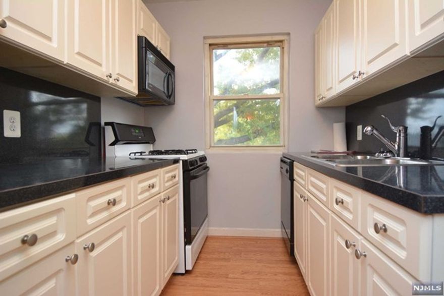 Lovely, clean, updated unit. Bright inside w/windows in all rooms. Desired parklike setting in well maintained complex. Private quiet, corner building tucked away w/no one walking by. 3rd - Top floor with no one above. Short flights to floors. Large 1 BR w/dining area that could work well as a home office or den. Renovated Kitchen offering tile flooring, double sink, ref., D/W & AC unit (As Is) Sparkling hardwood floors and ample closets throughout. On site parking included. Storage for extra minimal annual fee. Extremely convenient, 1 min to NY trans, close to houses of worship, eateries and stores. Will not last! Credit check, application and tenants insurance required.Tenant to pay 1 mo fee, 1st mo rent & 1.5 security dep to move in.