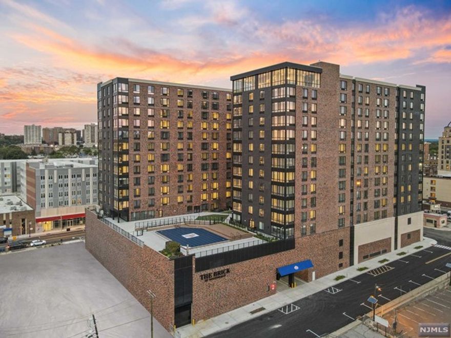 The Brick of Hackensack is a Premier 14 story luxury residential high-rise, boasting New York City style amenities in the heart of Hackensack's vibrant up and coming downtown. The Brick features 378 upscale apartments, secure garage parking and approximately 8,000 sq ft of retail space along Main Street. This building offers tremendous amenities including 24 hour doorman, Amazon Lockers, state-of-the-art gym, and yoga studio. The 'Oasis' courtyard features a luxury lap pool with adjoining sundeck and extensive green to be enjoyed with every season. The Brick also features a community room which is a great place to work from home. The crown jewel is the top floor Sky Lounge which impresses with an approximate 2,200 sq ft expanse and features a thrilling floor to ceiling view of the New York City skyline. Every unit in this building is spacious with an open concept floor plan, has high quality materials, and has washer and dryer in unit. Best of all, the Landlord pays the Broker Fee