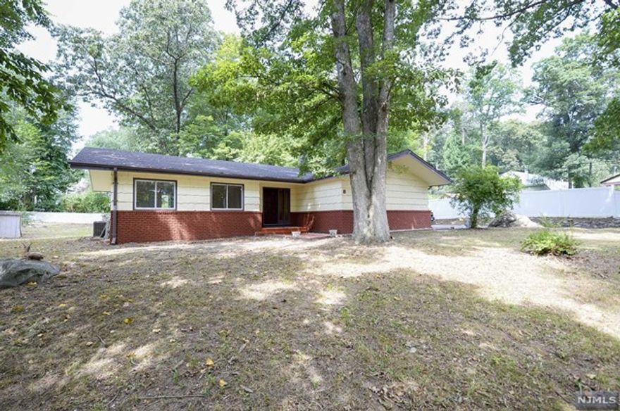 Discover this serene and private remodeled ranch-style home, now available for rent. Boasting 3 bedrooms and 1.5 updated bathrooms across 1,160 square feet of living space. The expansive yard and inviting deck create a secluded haven for outdoor entertaining or simply enjoying quiet moments. Newly refinished hardwood floors add warmth and elegance throughout, while the walk-in closet and ample storage cater to your organizational needs. The kitchen shines with stone countertops and stainless steel appliances, making meal prep a delight. The finished basement features washer/dryer hookups, adding convenience to this charming abode. Situated near the Lake Hopatcong public transit train line and Hopatcong State Park, you'll enjoy both the tranquility of nature and easy commuter access. The long uphill driveway provides ample space to house your boat and enjoy lakeside activities at a moment's notice. Experience this private gem for yourself and make it your tranquil sanctuary today.