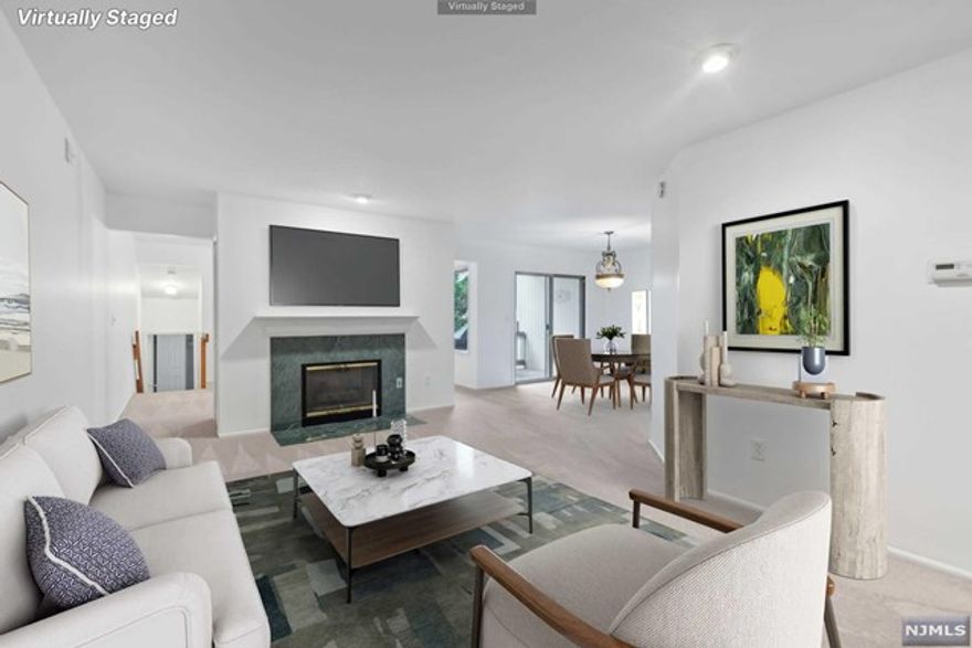 Beautiful, light-filled ground-level condo with 1-car garage, conveniently located in the desirable Scenic Hill community neighboring the 2000-acre South Mountain Reservation! This spacious turn-key unit is freshly painted throughout and updated w/ new carpets, recessed lighting & other upgrades. It has a great flow from the front entrance foyer with coat closet, leading into the living room with gas fireplace and sliding doors to a private terrace. The kitchen has stainless steel appliances and leads to the powder room, laundry closet, and access to the attached oversized garage with an additional storage area. Tucked away on the other end of the unit, you'll take the stairs to the lower level to find the spacious bedroom with full en-suite bath, double closets, parquet floors and access to a private and quiet rear patio space. This pet-friendly condo has fantastic amenities: outdoor heated pool, clubhouse, gym, trails to South Mountain and offers easy commute w/ NJTransit nearby