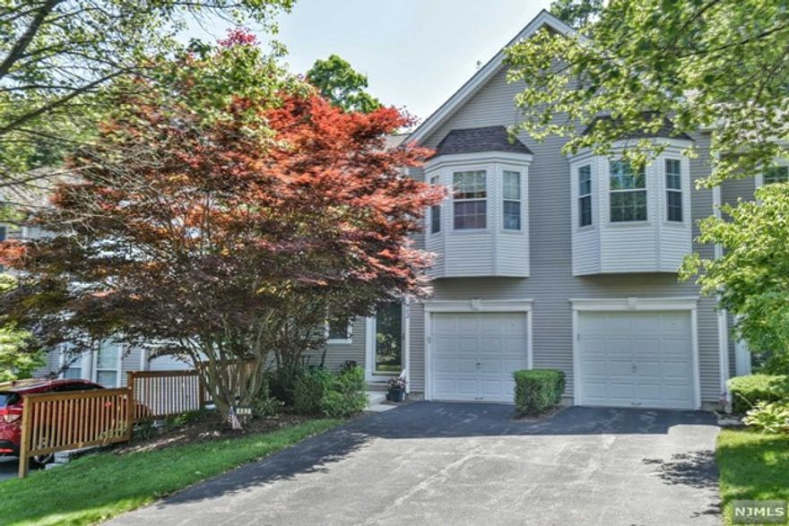 Welcome to desirable Birchwood Hills. This spacious 2 Bedroom, 2.5 Bathroom townhome is bright, open, and airy. Enjoy the beautiful eat in kitchen with granite countertops and sliding glass door that leads to a private oversized deck, 2 story great room with gas fireplace and formal dining area. Large primary suite with vaulted ceilings, bedroom, additional bathroom and laundry complete the second floor. Full finished basement with additional storage room and utilities. This fabulous location backs up to the woods to enjoy your privacy. Extra parking is just across the street. Full access to the clubhouse with pool, tennis, fitness room, and playground. Conveniently located near schools, library, shopping, and highways.