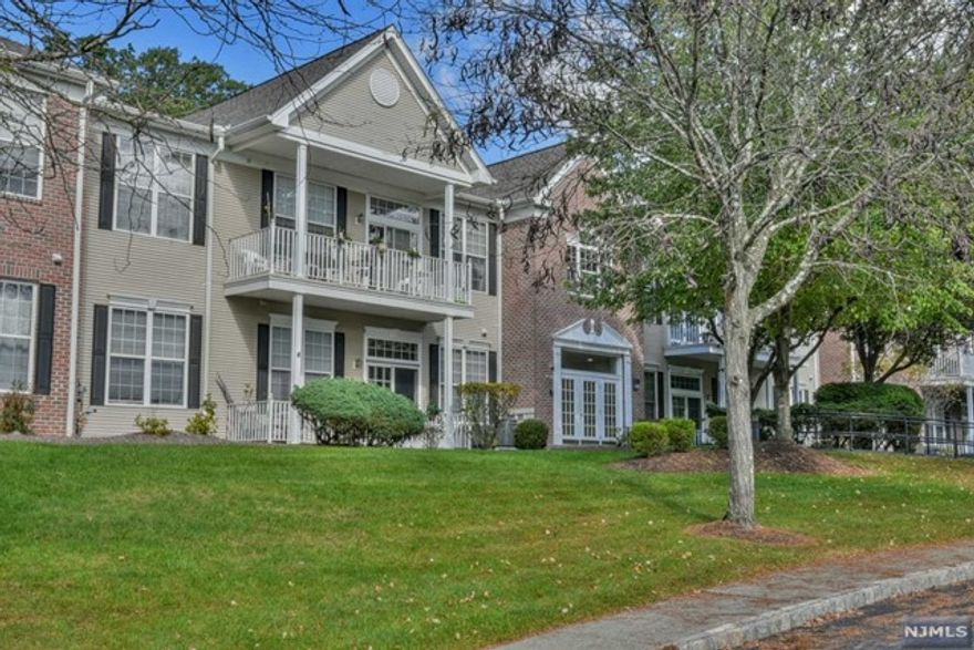 CREAM OF THE CROP! First time on the market- 1 original owner! HIGHLY DESIRED CORNER unit is DRENCHED IN LIGHT with upgrades throughout! Take the elevator to the 2nd Floor and fall in love with this gorgeous CHERRY model located right next to the Clubhouse, Pool & Tennis Courts! Gleaming Hardwood Floors, Custom Crown Moldings , Plantation Blinds, Custom Window Treatments, Custom Built Armoire w/ Lighted Bar Cabinets in Living Room, Custom Storage Solutions and Plenty of closets! Open the sliders and enjoy the views from your private Balcony. Your Primary Bedroom offers 2 walk in closets and large bathroom w/Soaking Tub and Stall Shower! Laundry Room in Unit! Garage Parking w/Storage Unit and shared storage closet upstairs, next to entrance! Gather at the Clubhouse, Relax by the Fireplace, Grab a game of Billiards, Workout in the Gym! Tennis Anyone? Take a Swim in the Summer! Enjoy nature on the Walking Paths that weave throughout the complex! please see floor plan for measurements