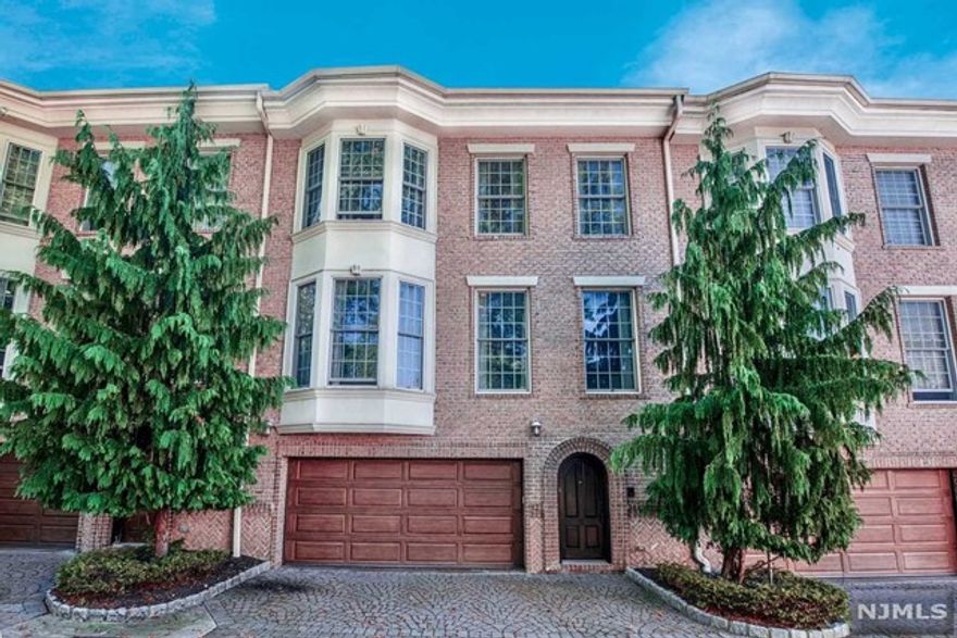 Location, location, location! Welcome to this Luxurious townhome featuring 3BR, 3.5 bath and a guest suite. Nestled in Fort Lee's heart, it's a stroll away from the library, eateries, schools, parks, and easy NYC commute. This is a 5-unit complex with a charming brick facade and in a private setting. Ground level: 2-car garage, entry foyer, coat closet, guest suite, utility room. 1st floor: open layout, 10-foot ceilings, modern eat-in kitchen with high-end appliances, granite countertops, ample storage, reverse osmosis system. East-facing living rm with floor-to-ceiling corner built-in, wood-burning fireplace. A convenient powder room completes this level. 2nd floor: 3BR including primary suite with spa-like bath. Fill your tub via the spout recessed in the ceiling and indulge in relaxation. Main bath, skylighted hallway and laundry round out the 2nd floor. Beautiful craftsmanship, gleaming hardwood floors, and elegant crown moldings, adding to its overall allure.