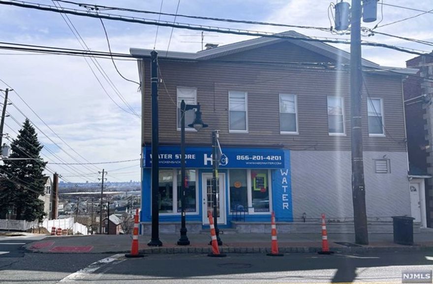 DESIRABLE LOCATION - GREAT INVESTMENT OPPORTUNITY OR HOME OCCUPIED This property is located on a corner of a busy business/residential street. It is an ideal location for a business establishment with owner occupied or a rental apartment on the second floor. The location has an amazing view of New York City. There is a separate entrance to the second floor apartment. The first floor is currently used as a business. This space has five storage rooms. It can be used as a business or converted into an investment opportunity. The basement has six rooms which are currently used as storage for the business. From the second floor apartment you see new York view . features, 2 bedrooms, living room/dining room combo, modern eat-in kitchen with stainless steel appliances and marble countertops. . Updated bathroom. Plenty of custom made closets . There is a one car garage which is attached to the building. Close to public transportation, worship, stores.