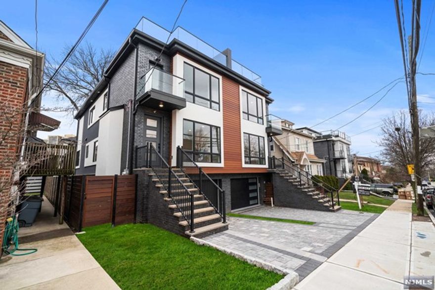 Welcome to 83 Crescent Ave, A Modern Contemporary Design Townhouse featuring a Sleek Exterior Design with Black Brick and Oversized Anderson Windows... 4 Levels of Living Space with Rooftop Deck with NYC and Hudson River Views...Open Concept on Main Level with 9 ft Ceilings, European Style Kitchen with Oversized Island, Living Room with Gas Fireplace, Dining Room, and Deck...Primary Suite with Balcony, double closets and Spa Like Bath, Two Additional Well Appointed Bedrooms with Full Bathroom in Hallway.... Loft complete with Wet Bar, Half Bath, and Rooftop Deck....Ground Level with garage, Recreation Room, Full Bath, and Sliding Door to Enclosed Yard....