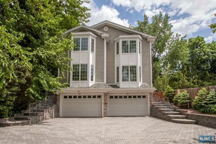 Enjoy luxurious living in this young, side by side two family duplex with many fine amenities! This lovely 5 bedroom, 4.5 baths residence offers many fabulous features, such as hardwood floors throughout, large closets, a cherry kitchen with granite counters and top-of- the-line stainless steel appliances. The family room boasts a gas fire place and French doors that lead to a patio. Each room is wired for internet. Central vacuum, alarm system, walk-out basement and so much more. Two car garage with paver driveway. This home is set back on a beautifully landscaped property. Fabulous curb appeal, and conveniently located near the center of town, transportation hubs, schools, houses of worship and shopping. An absolute must see! Landlord has New Jersey real estate license. Landscaping is included in the rent. Snow and ice removal are the responsibility of the tenant.