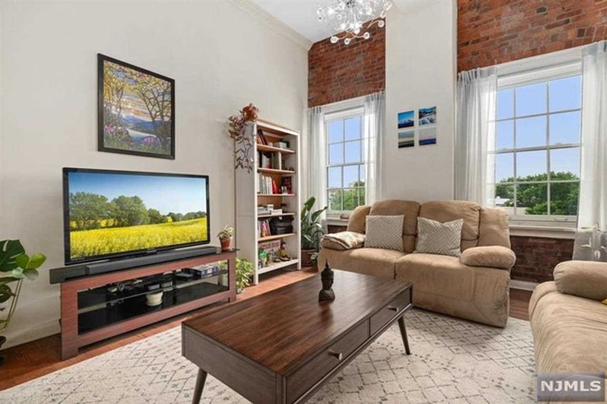 Welcome to the Market, 347 Varick St unit 417A at the ever-popular Dixon Mills! Are you looking for a more spacious 2 bedroom with parking within a short distance to the Grove Street Path? Well, you found it. This 1196 square feet 2 bed 1.5 bath home is calling your name. Don't settle for a 2 bedroom under 1000 square feet, when you can simply choose 417A! This exceptional condo is located on the top floor, advantageously situated along the ever sought after, south side exposure. Feel the nourishing energy from the sunlight flooding the home. 417A has large, high-quality, custom Pella Architect Series windows to usher in that lovely sunlight, which were replaced only a few years ago. True Homeowners understand the value in quality. Enjoy cooking wonderful meals with your loved ones in this u-shaped kitchen, completed with all up to date stainless steel appliances, ample counter space and accommodating cabinetry. Signature high vaulted ceilings this gives home amazing volume.