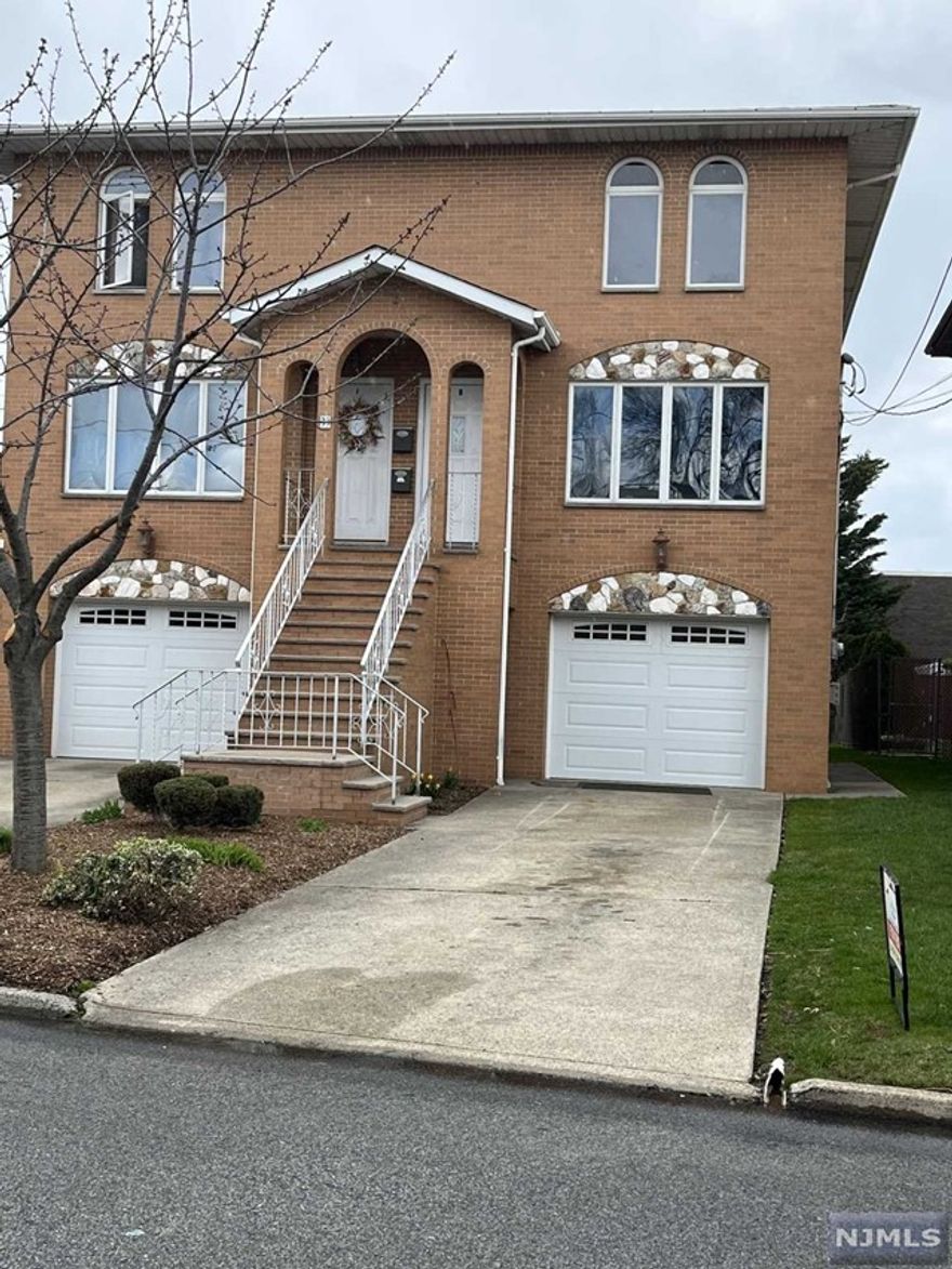 very spacious & full sunny facing south east duplex. First floor features great size living room, formal dining room, 1/2 bathroom and eat in kitchen with sliding doors walking out to a large BRAND NEW deck. Second floor has master bedroom with master bath, 2 additional large bedrooms and second full bath with jaccuzi tub and stand up shower. NEW Painting. all NEW hardwood flooring on 2nd floor & refinished on first floor. all door, door knob & molding installed brand NEW kitchen counter top. kitchen cabinet refinished. include 1 1/2 car garage, Central AC, ample closet space, laundry in unit. Right side parking please .