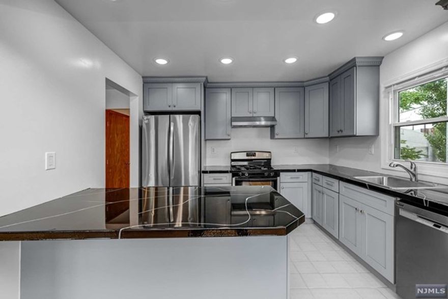 Super Spacious and newly renovated 2 bedroom 1 bathroom rental in a two family home. Open Concept Living and Dining. AMAZING brand new kitchen with Black Quartz countertops, a breakfast bar, and SS appliances. Gleaming Hardwood Floors throughout. Two HUGE bedrooms with custom closets in each. Spacious bathroom has also just been renovated! Includes 1 car driveway parking space and shared laundry downstairs. Close proximity to transportation into NYC, restaurants and shopping. Sorry, no pets. 1 month broker fee & credit check / income verification required. Utilities are responsibility of tenant + snow removal for driveway space / in front of driveway space responsibility of tenant.