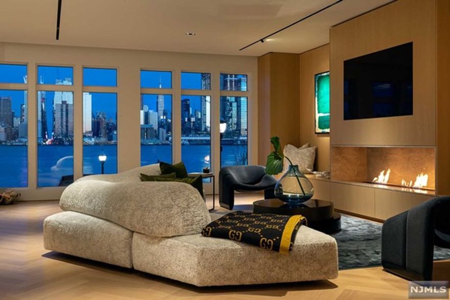 Sincere perfection in a sublime setting, 12 Henley Place breathes in Manhattan's beauty. Built on the waterfront plot that peers directly down New York City's iconic 42nd Street, a precise, three-year renovation created a refined home of international excellence. Every fine finish satisfies, both aesthetically and functionally. Ceilings, walls and stairs float. Select rift only, white oak herringbone hovers above concrete and rubber soundproof flooring. The Minotti-inspired kitchen is clad in complementing white oak with precise lines, sourced from Germany's Black Forest. Pillow-top sunrise scenery serves as a circadian clock. Mitered edge stonework, architectural lighting, and shadow-bead moldings create focal points. Ventilation and sound speakers are invisibly integrated. Mahogany, Italian marble and gun metal accent an elevator that rests beside your private, heated, multi-vehicle garage. Ultimate comfort is abundant, even for the most discerning.