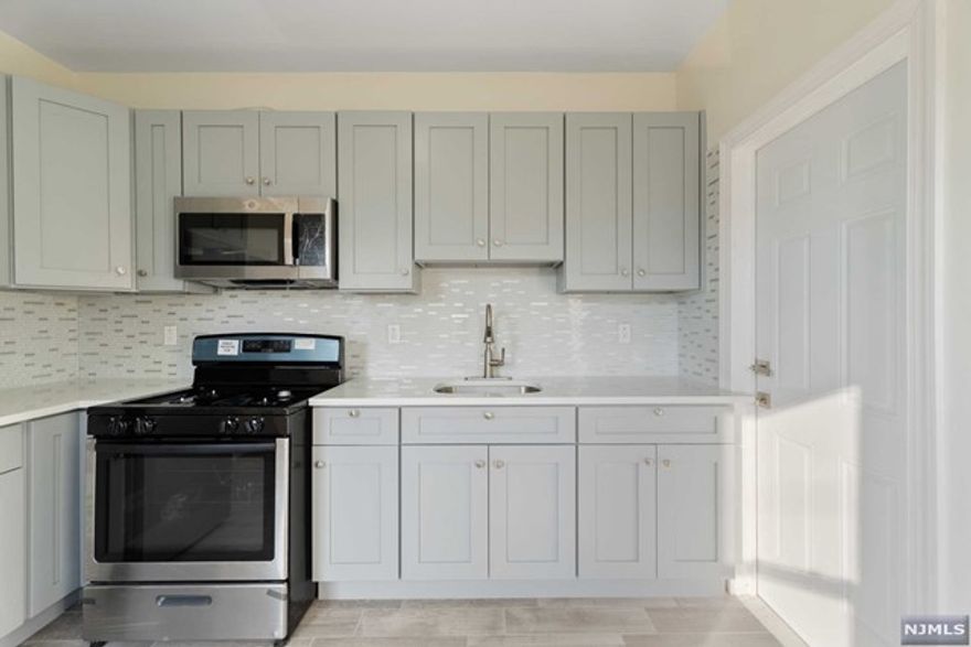 This fully renovated 3 bedroom, 1 bathroom apartment boasts brand new everything! Enjoy a fresh start with new walls, ceilings, floors, kitchen cabinets and appliances, plus a completely remodeled bathroom. The modern design features sleek grey flooring and bright white walls, creating a clean and spacious feel. With two parking spaces in the driveway, you'll never have to worry about street parking. This location offers the best of both worlds - close to Eastside Park for outdoor recreation, and convenient access to major highways like Route 21, the Garden State Parkway, and Route 80. Commuting to NYC is a breeze, whether you prefer driving (30 minutes to Port Authority) or public transportation (1 hour). Background check, credit check and income verification required.