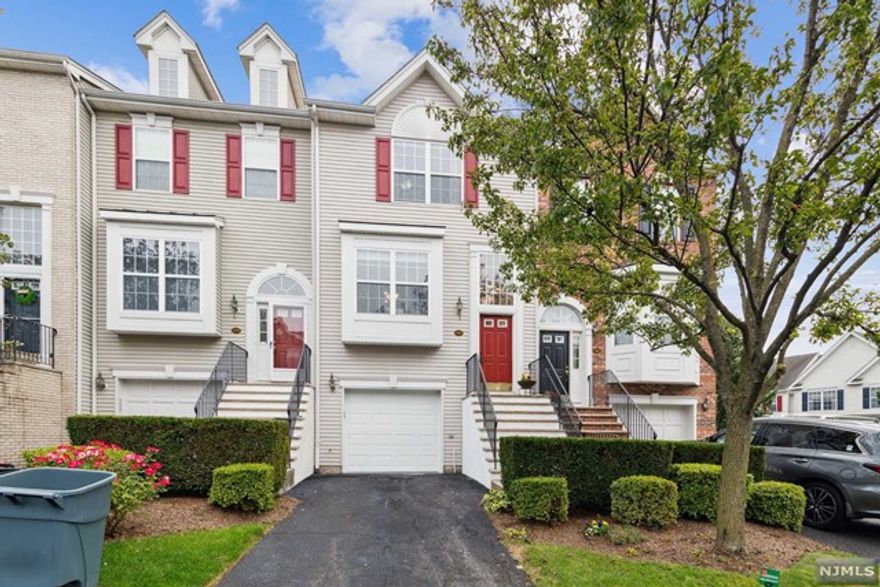 Tri-level unit with nearly 2000 SF, this townhome features hardwood floors thruout, crown molding, ceiling fans & a second fireplace in lower level family room with walk-out to private patio overlooking cul-de-sac. The main level kitchen with quartz counters and 42" cabinets is open to breakfast nook and a living room/dining room combo with gas fireplace. Lots of natural light. Laundry conveniently located on bedroom level. Spacious master bedroom with master bath. Second bedroom and full bath completes the third level. Clubhouse with gym and pool, tennis courts, jogging path & playground on premises. This beautiful gated community has it all! Walk to NYC trans, shopping & restaurants. EZ access to maj. highways and only 9 miles to NYC. Lots of beautiful parks and great restaurants in town.