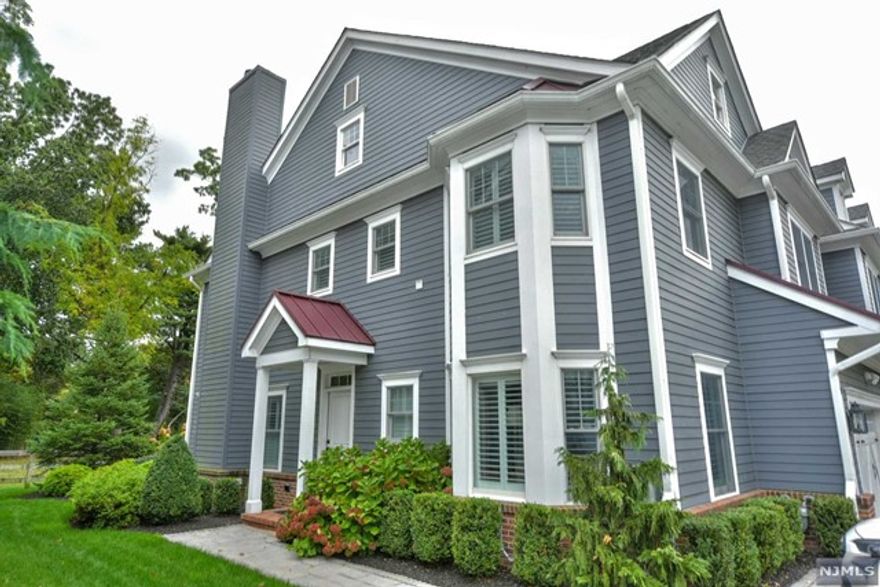 Step into this stunning end-unit townhome featuring 3 bedrooms and 2.5 bathrooms in the Barrister Court at Dunkerhook complex, a premier 55+ community. Adjacent to Saddle River County Park with a private walking trail access, this home offers a serene setting. The main level includes an entry foyer, half bath, and open living room with gas fireplace and dining area leading to a spacious kitchen with center island, quartz countertops, and stainless steel appliances. Sliding doors off the dining area open to a private patio, perfect for relaxation and entertaining. A home office and 2-car garage complete the first floor. Upstairs, find a spacious primary bedroom with ensuite bath and ample closet space, along with two more bedrooms and another full bath. The unfinished basement provides versatility. Hardwood floors and elegant finishes enhance this home. Conveniently located near transportation and shopping, this property is a true gem on the Paramus border in desirable Fair Lawn.