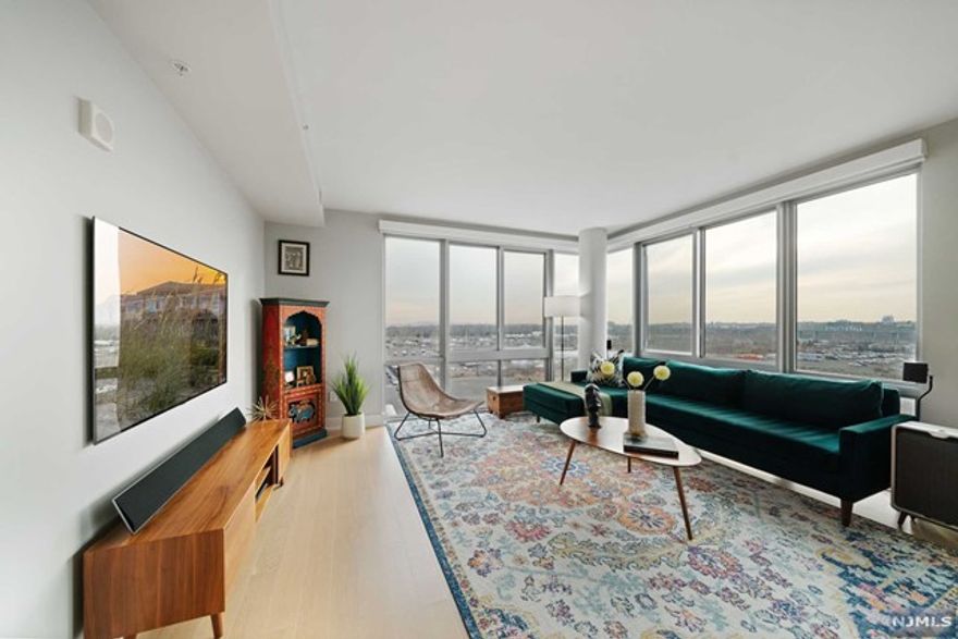 Welcome home to this rarely available South-West corner unit at the luxurious Gulls Cove II overlooking Hudson Point Marina. This spectacular home offers 3 bedrooms & 2 baths spanning over 1800 sq ft with a thoughtful floor plan maximizing privacy for the bedrooms. Floor-to-ceiling windows wrap around the whole home flooding it with an abundance of natural light, and two standing balconies bring the outdoors in. The enormous chef's kitchen is outfitted with modern Eggerman's cabinetry, Quartz countertop and backsplash, Kohler fixtures and Bosch appliances. Open concept dining and living room make it a truly incredible space for entertaining. Bathrooms are appointed with Porcelain floors/shower tiles and glass tile accents. Abundant closet space throughout the home: custom California Closets inside the walk-in-closet in the primary bedroom, two closets in the 2nd bedroom, one in the 3rd bedroom, and two large coat closets in the foyer. Gleaming engineered hardwood floors throughout