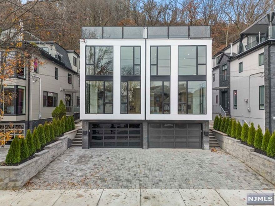 Designed & Built by SILVERLINE - 4-Level ULTRA-Modern Townhome with approx. 5000 sqft OVERSIZED LOT. Massive Open Concept Layout w/ Gigantic Pella Windows & Custom Wide Plank European White Oak Flooring. Enormous Chefs Kitchen Built w/ Modern European Cabinets, Sleek Floating Countertops, King-Size Kitchen Sink, Dedicated Fridge Column & Dedicated Freezer Column, Wine Cooler, & Overwhelmingly Large Kitchen Island. Third Level Boasts 3 Oversized Beds & 3 Full Baths - Retreat to The Spa Like M. Bath w/ Heated Floors, Large Freestanding Tub, Glass Rainfall Shower, Dual Vanities. 4th Level sits atop w/ Large Bed/Office & separate Rec room w/ Private Bar Leading To Extra-Large Roof Deck w/ Breathtaking Views Of Manhattan. 4 Zone Heating & Cooling, C/Vac, Spray Foam Insulation. Smart Home Enabled- Ultra Quiet WIFI Garage Door Opener, & Built-In Security Camera