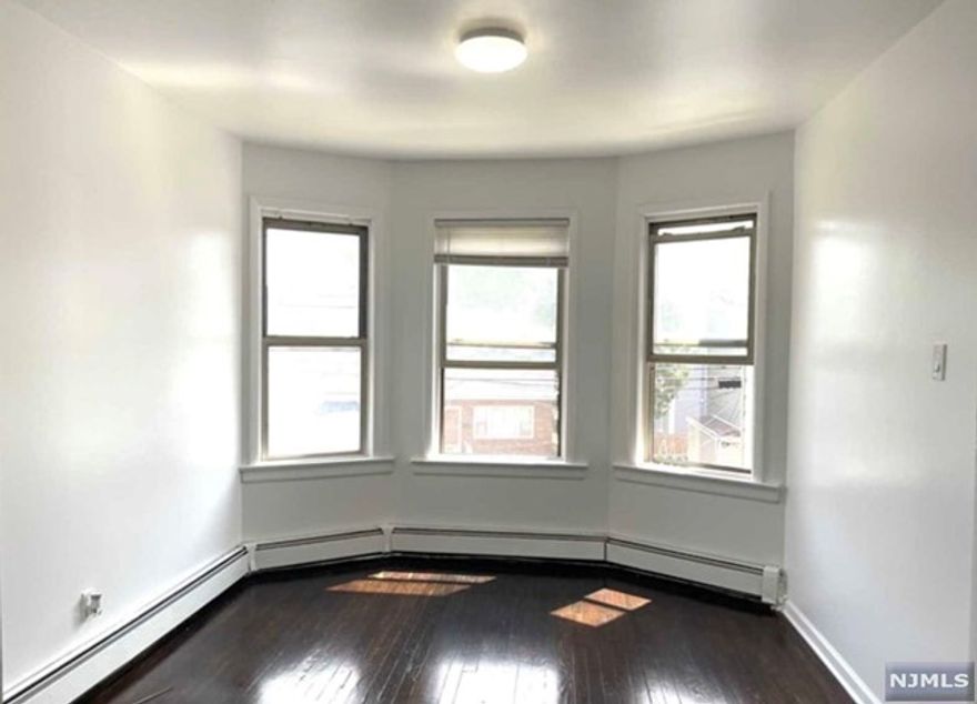 Bright, Smoke-Free and spacious 2 bedroom apartment with living room, dining room, Brand New kitchen and full bath. Wood floors in living room and dining room. Close to transportation, parks, schools, shopping and houses of worship. Separate utilities. Right to use Back Yard. Harrison Path is only a 10 min drive away! Or have the convenience of the bus which can be caught either on Kearny Ave or Davis. Street parking only. 1.5 month deposit and tenant pays 1 month broker fee.