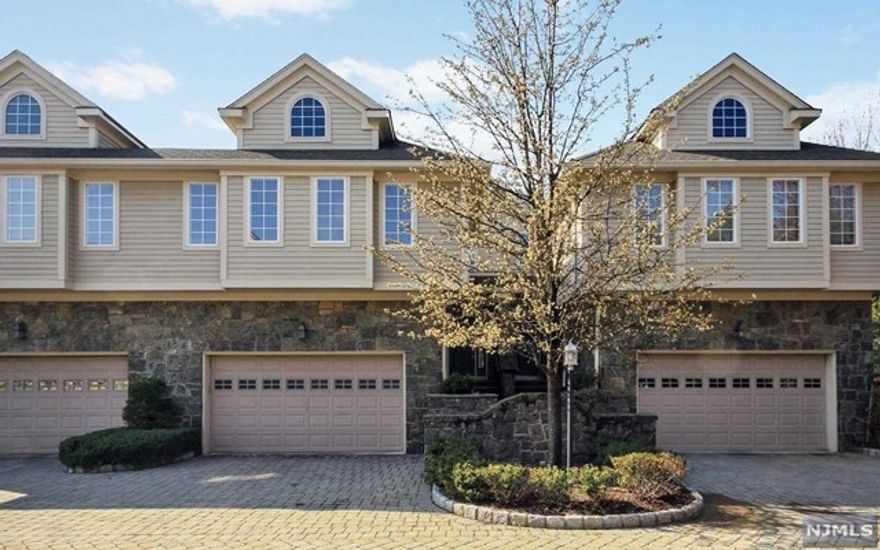 This gorgeous unit in the upscale Victoria Square Townhouse community is located on the east hill of Tenafly. The handsome exterior is stone faced with hard-plank construction, paver driveway and lush landscaping. The entry foyer leads into a spacious and airy living room with fireplace, lovely built-ins, crown moldings, hardwood floors and french doors to a private paver patio, formal dining room, large gourmet kitchen and breakfast area offering granite countertops and stainless steel appliances. The second level has a huge master suite with siting area, large walk-in closets, master bath with jacuzzi, 2 additional bedrooms plus large bathroom. The lower level has a recreation room, full bath and lots of storage.