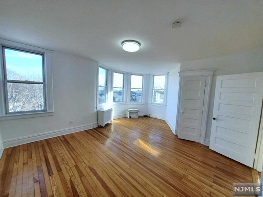 Spacious, airy, bright and beautiful! Private top floor apartment of classic Victorian with glimmering nighttime views of NYC skyline. Large sunny Living Room, with turret style windows facing eastward, opens to second living area that can also be used as formal Dining Room, Office, etc . Renovated Kitchen, with small side room, features Shaker cabinets, new flooring and brand new stainless appliances including fridge, dishwasher, and gas range with vent hood. Fresh new renovated bathroom in neutral colors and 2 Bedrooms complete the apartment. Highlights include refinished hardwood floors throughout, good closet space, use of garden and Heat and Water INCLUDED in rent!! Close to downtown West Orange, Eagle Rock Reservation and Montclair and Bloomfield restaurants and shops. Close to NYC transportation and free jitney.