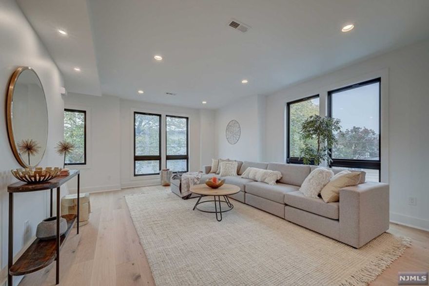 Beautiful new construction multi-floor, 2-family apartment with large finished basement in walking distance to Bay St. Train Station and downtown Montclair. The apartment features hardwood floors, recessed lighting, Central AC and Heat. The second floor has an open concept living room, modern designer kitchen with a breakfast island, small mud room & bedroom with 2 walk-in closets. The finished third floor has 2 full bedrooms, one with a with 2 large closets and another with french door which could also be used as an office or recreational room. There is also another full bathroom and laundry. There is a 2 car width driveway which is getting repaved in the coming days and a back yard.