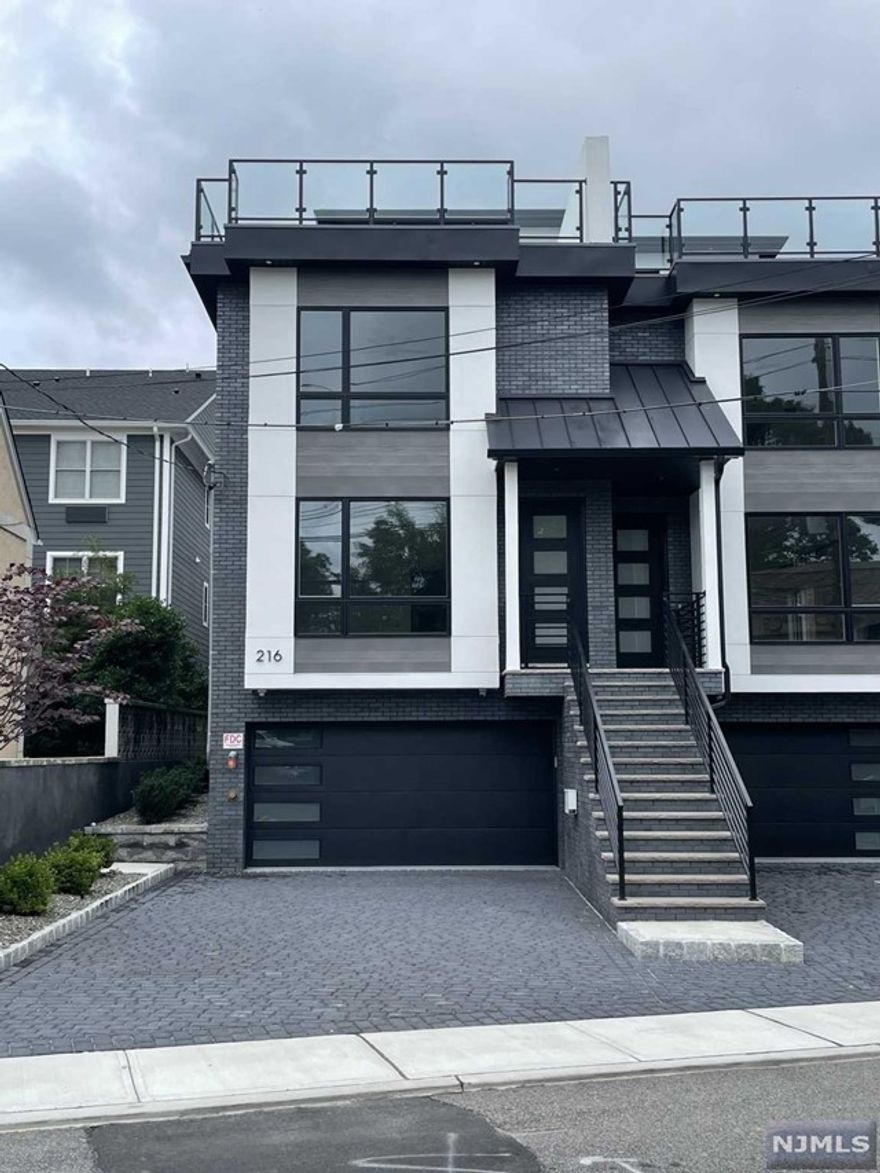 Brand New Modern 3,100 SQFT Boutique Style Townhome with Rooftop deck! Open Concept Layout w/ Prefinished Engineered Flooring. Main Floor Features: Living Room w/ Modern Fireplace, Dining Area, Coved Lighting Around Entire Floor. Large Kitchen W/ Sleek Modern Cabinets, Gen Air Appliances, Quartz Countertops, Oversized Island, Butler Pantry with Cooler, Front Security Camera Included Bedroom Floor Consists Of 3 Beds & 2 Full Baths - Main Bdrm w/ Spa Like M.Bath w/ Heated Floors, Large Freestanding Tub, Glass Rainfall Shower, Double Vanities. 2 Zones of AC/Heat. Top Floor Features Large Roof Deck, Rec Room, Wet Bar w/ Beverage Fridge, Half Bath. Ground Level WiFi 2 Car Garage Door, Custom Bench w/ Shiplap, Rec Room, Half Bath, & Much More! Walking Distance to NYC buses and bus to NY Water Ferry