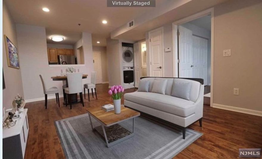 Recently Renovated! Welcome to this spacious 1 bedroom apartment in City Views at West New York. Drive up to the gated garage and park in your own assigned space! Long entry foyer leads into chef's kitchen with open pass through for entertaining guests. New hardwood floors open up into the large living room and dining area. Bedroom has plenty of closet space with sun-filled windows. Laundry in unit! Close to shopping on Bergenline, NYC transportation, and Port Imperial. Non-smoking unit, no pets please!