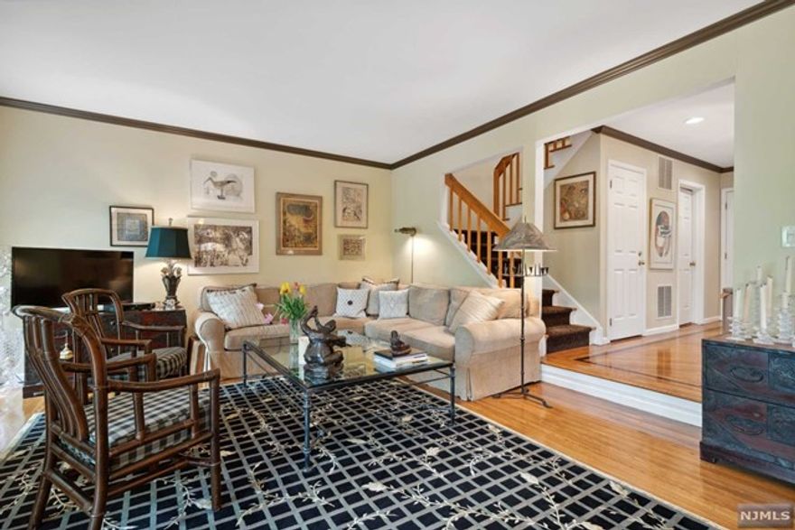 Nestled on a lovely private lot with wooded views, this bright sunny end unit offers easy living. The home features new gleaming hardwood floors on the first floor, a remodeled eat-in kitchen with granite countertops, stainless steel appliances, and a family room, as well as a large open concept dining and living room area with a gas fireplace and two sliders that open to a large 17' x 15' deck. A laundry room with new custom cabinetry and a powder room complete the main level. Upstairs, an exquisite master bedroom boasts a master bathroom with soaking tub and shower, a large walk-in closet, a private deck, and a gas fireplace with remote. Two other bedrooms and a full bathroom complete the second floor. Additional highlights include a finished 25' x 22' basement with a recreation room and storage area, 2 skylights on the second level, an additional private deck off the third bedroom, an attached 1-car garage with additional parking, and a freshly painted exterior.