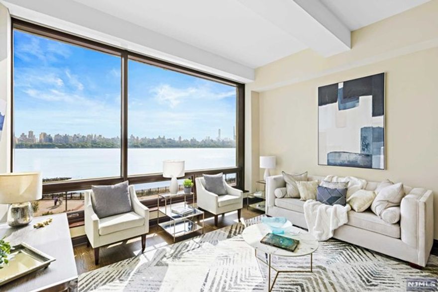 Loft living along the Hudson River reimagined. Extraordinary for its open, flexible layout, jaw-dropping panoramic views of the Hudson River and New York City, incredible all-day light, 12-foot ceilings, garage parking for two cars and its amenity-laden environs within the esteemed waterfront enclave, The Pearl, Residence 311 is an exceptional 1,468 SF two bedroom, two bathroom loft that includes a 24-hour concierge, free private shuttle with direct service to the NY Waterway Ferry at Port Imperial, and is just a two minute walk to the NJ Transit express bus that services Port Authority. An oversized, open-concept living and dining area is illuminated by floor-to-ceiling windows that dramatically frame New York City's most iconic buildings while it is enlivened by a uniquely updated and renovated open kitchen with expanded bespoke millwork and storage, integrated Sub-Zero appliances including 36" refrigerator, two 24" beverage drawers and a column wine refrigerator.