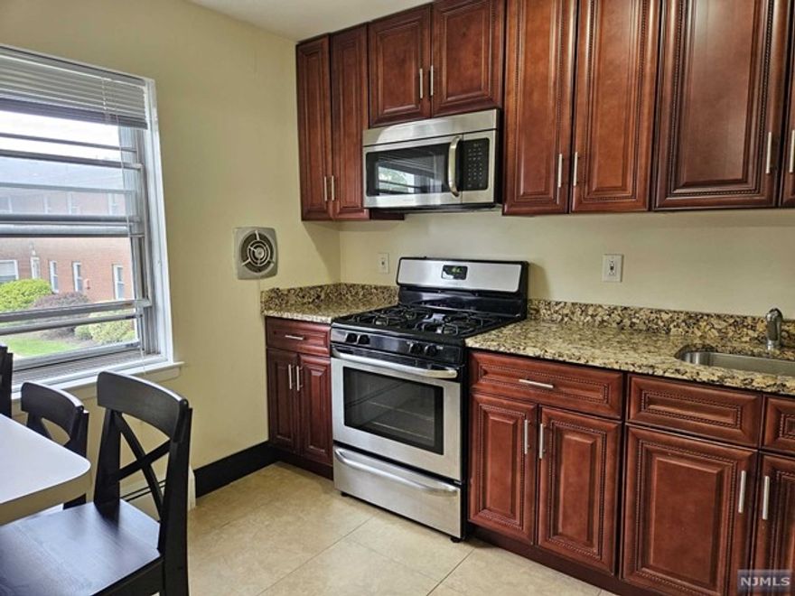 AMAZING RENTAL OPPORTUNITY! RENOVATED FIRST FLOOR CONDO WITH ONE CAR GARAGE (additional fee) AND EXTRA PARKING SPACE. BRIGHT AND OPEN WITH HARDWOOD FLOORS THROUGHOUT . KITCHEN WITH STAINLESS STEEL APPLIANCES AND GRANITE COUNTER-TOPS. FANTASTIC LOCATION IN THE CENTER OF TOWN CLOSE TO SHOPPING, SCHOOLS AND RESTAURANTS. BUS TO THE CITY JUST STEPS AWAY. GREAT COMPLEX WITH OUTDOOR IN-GROUND POOL! HEAT AND WATER INCLUDED. TENANT RESPONSIBLE ONLY FOR ELECTRIC. Will be freshly painted and professionally cleaned.