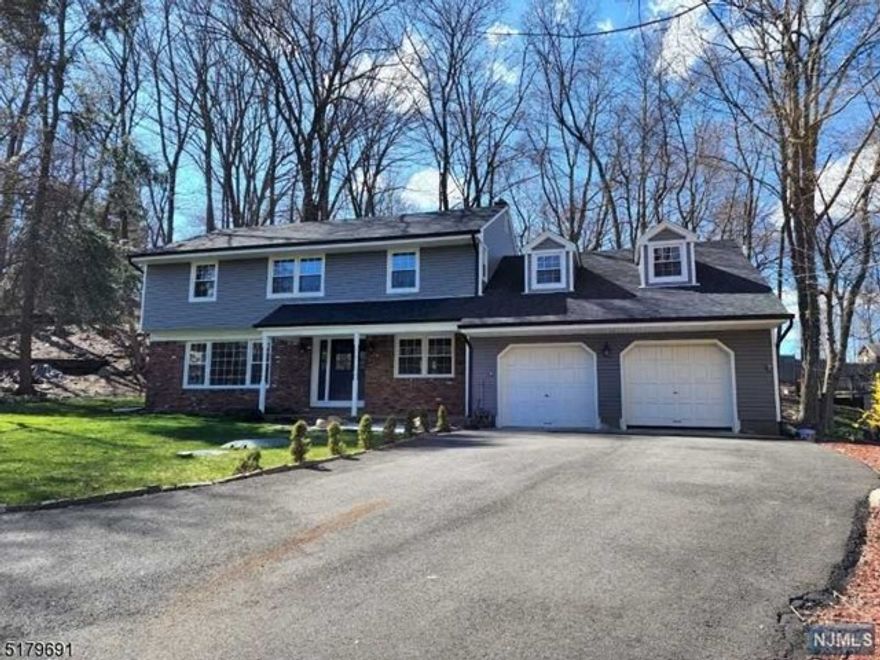 Beautiful colonial. Primary bedroom with full bath, 5th bedroom boasts a half bath, 3 additional bedrooms and a large bonus room. Entry foyer, formal living room with picture window views of the pond, formal dining room, family room with woodburning fireplace, eat-in kitchen, quartz countertops and stainless steel appliances. Large laundry room/mud room with two entrances, into the 2 car garage and the right side of the home. Hardwood floors throughout the entire house, newer central air conditioning. This home peacefully sets back from Long Hill Rd. The home has 180' of setback from the street to the house.