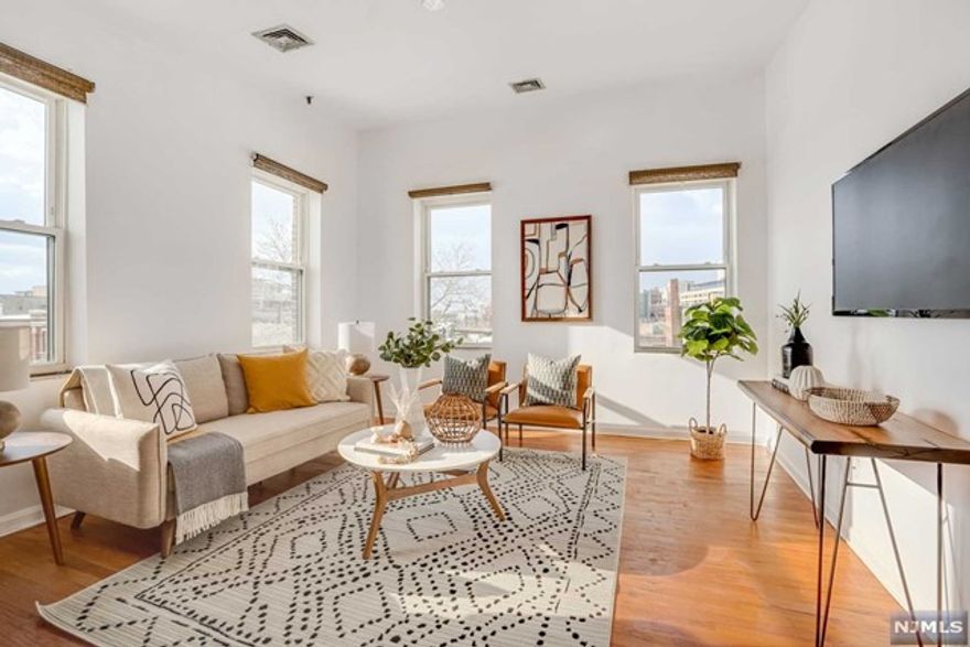 Priced to break the rent habit (with LOW taxes and maintenance fees)! This unit is a Commuter's Delight! From this location, Newark Penn Station is only 2 blocks away and in close proximity are Newark International Airport, Ferry Street and its lively restaurants, shops and entertainment venues. Bright and airy, this Loft-like corner unit has expansive oversized windows, soaring ceilings and a well-dispersed living space, ideal for work / live scenarios and entertainment. Dine-in and enjoy the well-appointed kitchen with granite countertops, ample cabinets and stainless steel appliances. You will also love the updated bathroom and generously-sized bedroom. Other highlights include exposed brick walls, on-site laundry facilities, hardwood floors throughout, central AC, a garage parking space (1 block away), a skylight and access to a tranquil outdoor courtyard!