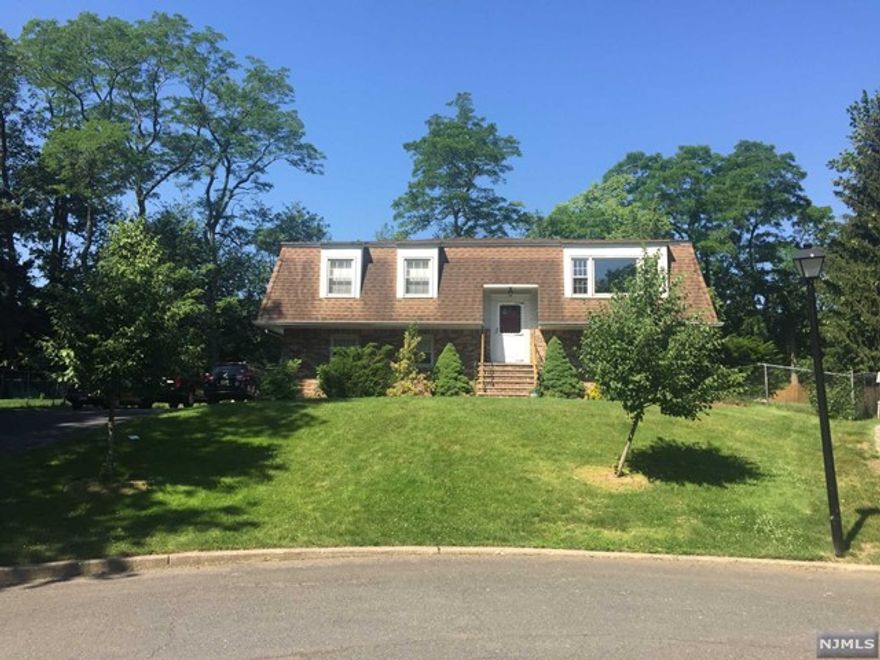 Gorgeous home situated on a quiet cul-de-sac close to schools, NYC transportation, downtown area. Owner has spared no expense remodeling this beautiful home. Beautiful entryway leads guests to a spacious living room drenched with natural light. Chefs will delight in the completely remodeled kitchen featuring beautiful wood cabinets and granite countertops. Breakfast bar is perfect for quick meals and Is adjacent to dining room. Glass sliding doors give access to deck off dining room overlooking lower patio and large fenced in yard. Off of the main hall are 2 spacious bedrooms, main bath and large master bedroom w master bath. Lower-level offers large family room, large bedroom, full bath, laundry area and access to rear yard as well as attached two car garage with storage room. *Owner Holds NJ Real Estate License*