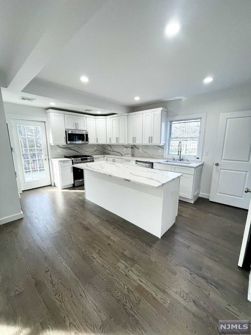 Move right in to this tastefully renovated home in the heart of Cresskill only steps from the bustling town center & highly ranked Cresskill High School. This sun-drenched home features a large inviting front porch leading to the entrance foyer, spacious open concept living/dining/kitchen area w/brand new custom cabinetry, stainless appliances, quartz countertops, tile flooring & door to the oversized private deck area overlooking the rear yard, & a brand new powder room complete this level. 2nd level has a good size primary w/a brand new primary bathroom, 2 additional bedrooms & one additional new full bath. There is a full unfinished basement that's ideal for storage. This move in ready home will have a new driveway, gleaming refinished hardwood floors, freshly painted, updated windows & a private rear yard. Amazing opportunity to live in wonderful Cresskill with its highly ranked schools and diversified downtown district featuring lovely shops & wonderful eateries