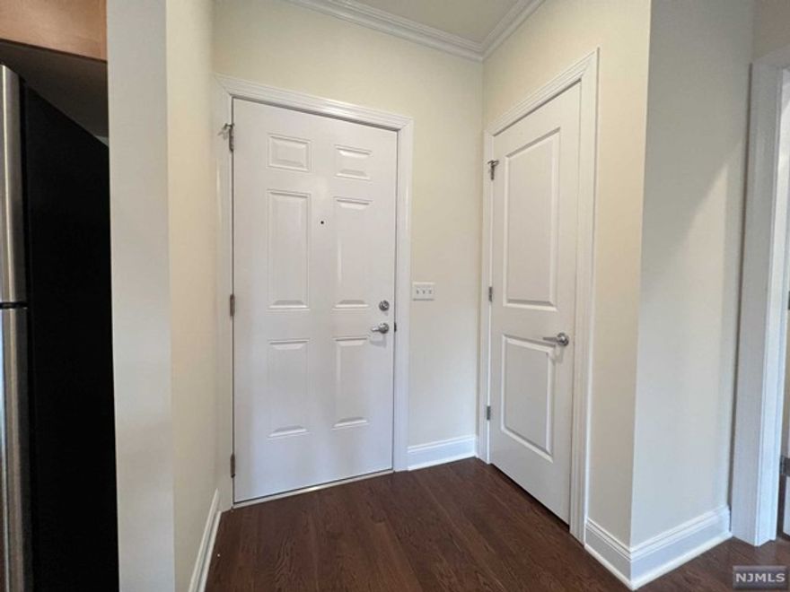 Welcome to a boutique 18-unit condominium built in 2008. This 1149 sq. ft. 2BR 2FBth condo features a split bedroom layout, high ceilings, hardwood floors, and a living room with a Juliet balcony. Conveniently located on the first floor, no need to wait for an elevator. . Recently painted and equipped with a brand new water heater. Washer/Dryer in the unit, Central A/C. Includes 2 garage parking spots. Commuting to NYC is easy with the NJtransit #153 & #159 buses at Anderson Avenue. Food Bazaar supermarket is around the corner, and other shops and cafes are nearby for your convenience...