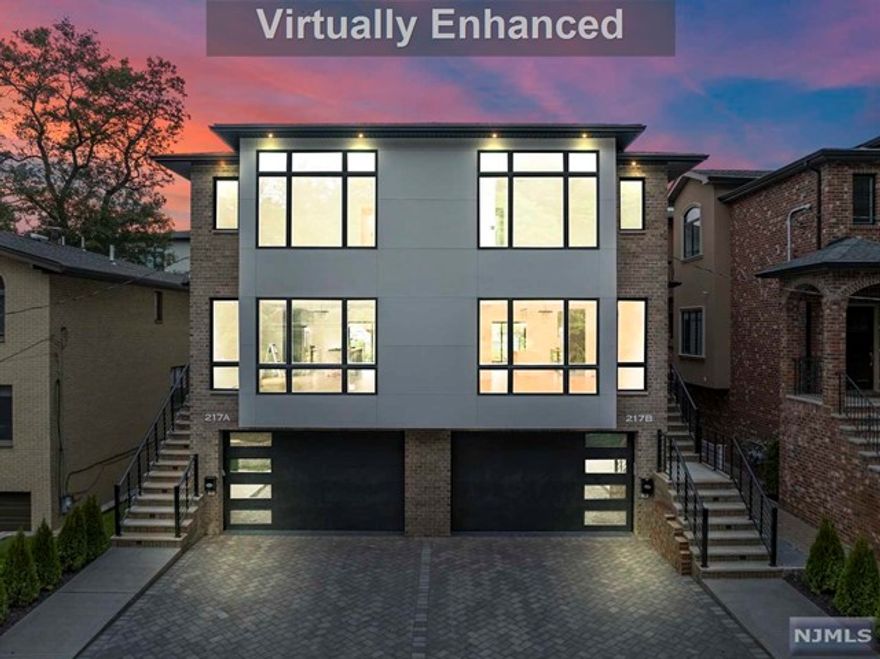 Welcome to Luxury living at its finest 2 minutes from GWB. This duplex is a showcase of exceptional craftsmanship & design, featuring coffered ceilings, a beautiful galley kitchen, a spacious living room graced by a cozy fireplace, & an unwavering commitment to the finest details. The ground floor showcases a spacious 2-car garage, mudroom and versatile bedroom/office space plus full bath. The 1st floor unfolds to reveal a large living room adorned by the warmth of a fireplace. The well-appointed galley kitchen is a chef's dream, it seamlessly connects to an adjacent dining area. A thoughtfully placed powder room completes this level. Step outside to the deck, perfect for relaxation & outdoor gatherings. Ascend to the 2nd floor to discover the luxurious master bedroom with its own sun-drenched master bath. 2 additional bedrooms and a full bath plus a dedicated laundry area. Located minutes away from NYC Transportation, Shopping, Resto & Schools.