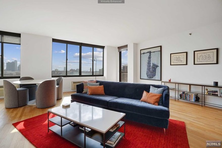 Home # 8G is incredibly cozy and spaciously designed two bed two bath, just under 1300 SF. When you enter you can feel the generous volume of space. Entertain & host your friends and family in this oversized sized living space with high ceilings and an open layout. Notice the City Skyline as the backdrop, take in the views off the private balcony, sip a cup of coffee or have a glass of wine. Imagine yourself living in this welcoming & bright home with tons of natural light coming in from the south, throughout the day. There is plenty of counter space & cabinetry in this U-shaped kitchen to prepare your favorite recipes. Bar stools for onlookers, as you dazzle and amaze them with your chef skills. The primary bedroom suite enjoys it's own ensuite bathroom and an ample sized closet that can house all of your belongings. One can easily set up a workstation and work remotely.