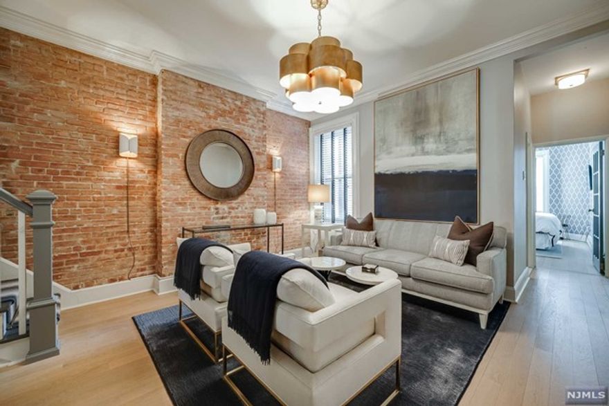 This beautifully renovated 3 bed / 2 bath 1450 sq ft duplex has it all! Combining old world charm with modern sophistication, enter this elegant designer home and enjoy the beauty of new white oak floors, stunning light fixtures and beautiful woodwork throughout. A well appointed kitchen on the first floor features stainless steel appliances and breakfast bar, a living room, dining room with custom built-ins and timeless original brick detail, and a guest room and full bath. The second floor has a primary suite with an abundance of closets, a second bedroom, chic living room, home office, full bath and a washer/dryer. Potential for a 4th bedroom With a private storage unit and a lovely common yard you have room for everything- you must see this truly special home!!