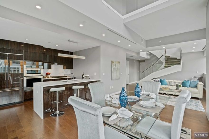 *TOM MCCARTHY 201-206-8144 & WAYNE BONSELL 607-239-0541 present: This extraordinary duplex features 2068-sf, with soaring vaulted ceilings & 3 private terraces that highlight spectacular river & city views. This dramatic top-of-the-world residence has amazing interior space on two levels connected by a floating glass rail staircase. Distinctive finishes include beautiful wood floors, quartz waterfall counters, contemporary cabinetry, exquisite porcelain tile, high-end stainless steel appliances and custom selected hardware & fittings. Building amenities include 24-hour concierge service, health club, media room, sports simulator, resident lounges and the amazing 3rd floor pool deck & barbecue patio. NY Waterway Ferry, Light Rail & NJ Transit Bus literally steps from the lobby door. Come experience living here! Due at lease signing: 1st month rent, 1.5 month security, 1-month broker fee, $300 Non Refundable move in fee, $1000 refundable damage deposit. (Photos from previous listing