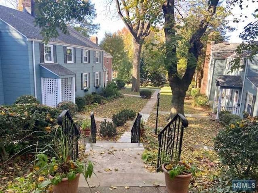 Rare opportunity to own a charming duplex unit in a serene 14 unit well maintained community with picturesque landscape. Private entrance to light-filled living room with newly redone hardwood floors, a wood-burning fireplace, cozy dining area and Kitchen. Kitchen comes with a new countertop, sink- faucet, newly repainted cabinets and In-Unit washer/ dryer for your convenience. Exit from Kitchen to a private lush garden area for those summer months barbeque. Storage area will be assigned in the basement by the board. This unit has all the amenities you could ask for, including central heat and air conditioning, newer roof, newly painted exterior, newer windows and even comes with "A GARAGE WITH A NEWER GARAGE DOOR', (Garage #5) assigned parking space plus guest parking space. Ideal commute to NYC with a bus just a block away.