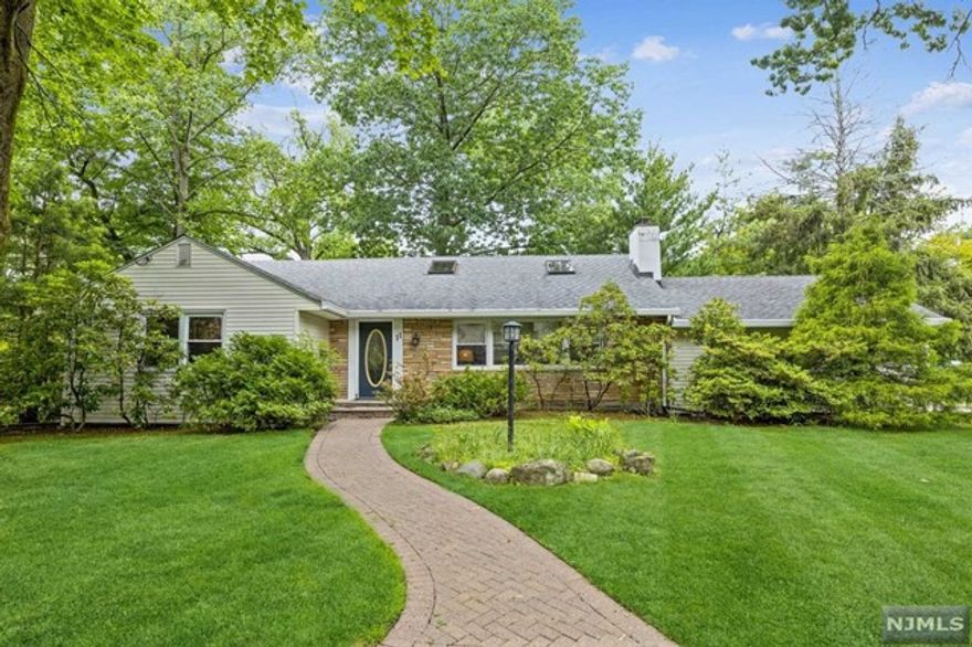 Spacious ranch home on Tenafly's east hill and a walk to smith elementary school. One floor living, open floor plan, exposed beamed ceilings beautiful hardwood floors and a wood burning fireplace. Updated kitchen with easy access to the dining, living rooms, back patio and yard. Beautifully renovated master bath and 2nd bath, full finished basement for additional livable space, bonus room and a full updated bathroom. Easy commute to NYC. Beautiful home and great a neighborhood!