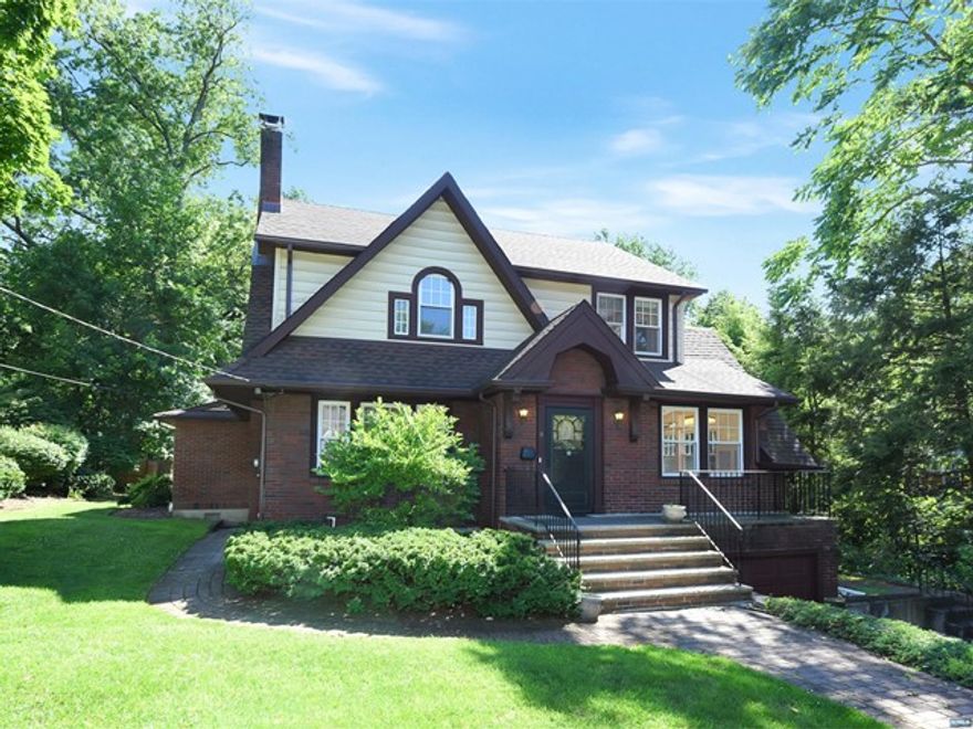 Welcome to a lovely colonial in the prestigious East Hill of Tenafly yet conveniently close to New York City. Tucked away on a private, quiet, tree-lined street, this charming home boasts a formal living room with a fireplace and a formal dining room featuring gorgeous stained-glass windows, archways and beautiful oak floors throughout. Enjoy entertaining in your modern eat-in kitchen with a large separate dining area. French door opens to a bright sky-lit family room and a large bedroom suite with an updated bathroom. The second level with new oak floors boasts 3 full bedrooms and a renovated bathroom. A fully finished lower level with new windows is equipped with laundry, play room and a utility room. Central A/C, sprinkler, alarm system, and a nice backyard. Ideally located near schools, walking-distance to center of town, city transportation, parks, shopping, houses of worship and award-winning schools. This home is the best of suburban living close to New York City.