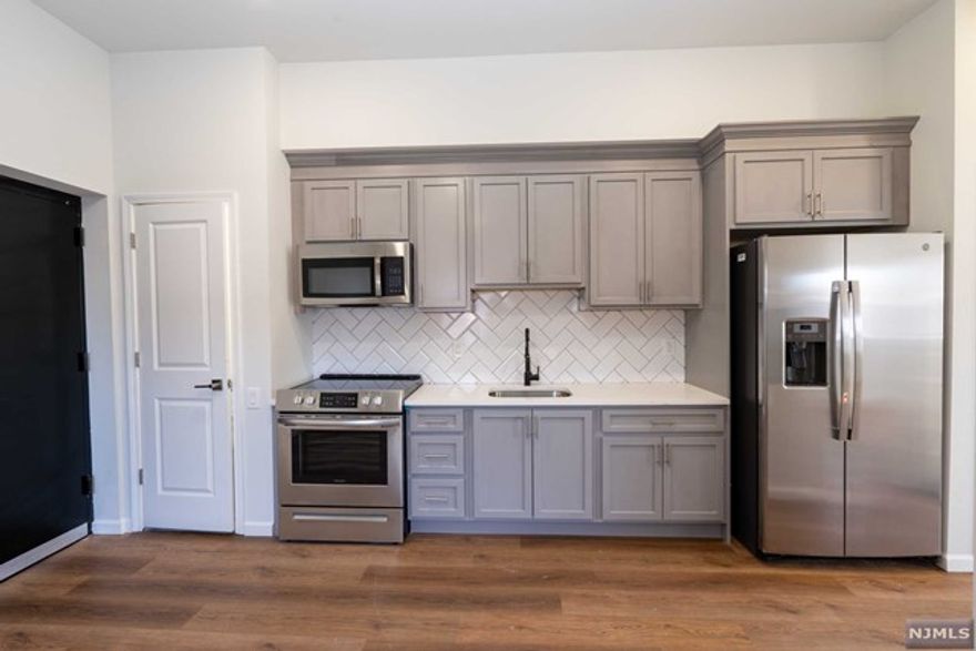 Welcome home to a Spectacular 2 year new construction one bedroom one bath unit. Plenty of natural light in all rooms will be sure to impress. This unit features a newer kitchen with shaker wood cabinets, stainless steel appliances, quartz counter tops and hard wood floors flowing throughout. Open concept kitchen & living room will make it easy to entertain guests. Large bedroom with Double closets. Plenty of closets, In unit laundry hookups & touch screen intercom system. Heated and Cooling wall units provided. The first floor units have elevator access if needed. Train station to NYC and or Bus transportation 4 blocks away..Park just a block away, municipal parking close by. Don't miss this Opportunity to occupy this beautiful unit.