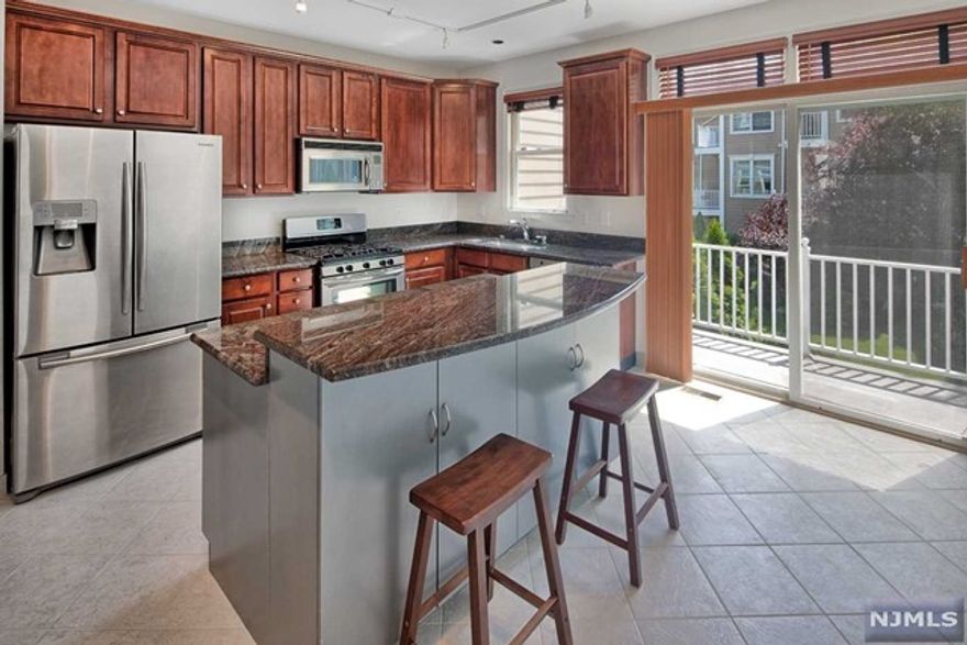 Unparalleled Essex style home just steps to the water with fabulous NYC views! Beautifully upgraded kitchen with granite counters and bi-level island with breakfast bar. Cherry cabinetry. Stainless steel appliances. Custom ceramic tiles. Custom painted. Custom light fixtures. Custom blinds. Half bath on bottom level. Central vacuum. Front load washer/dryer. Jacuzzi tub in master bathroom. Renovated vanities and medicine cabinets. California closets. Parking for two cars; one in private garage and one in driveway. Community boasts two pools with jacuzzis, tot lot, waterfront promenade and free shuttle bus to ferry and light rail. Steps to 158 bus to Port Authority. Close to restaurants and shopping. The Epitome of Waterfront Living!!