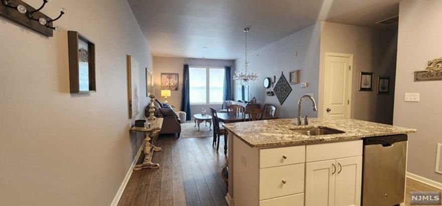 You will be WOW'd by this ultra clean and well kept unit. Located on the top floor, so there is no noise from above, this unit offers 2 bedrooms, 2 full Baths, in unit laundry connections. The Kitchen features stone counters, stainless steel appliances, Island with seating and open to Liv/Din Room Space. Extra high ceilings and large windows make the space feel warm and inviting. Both Bathrooms feature Tile Floors and Tub surrounds and stone countertops. Just minutes away from Hopatcong State park, Lake Hopatcong Train Station, Rte 80 &Rte 46