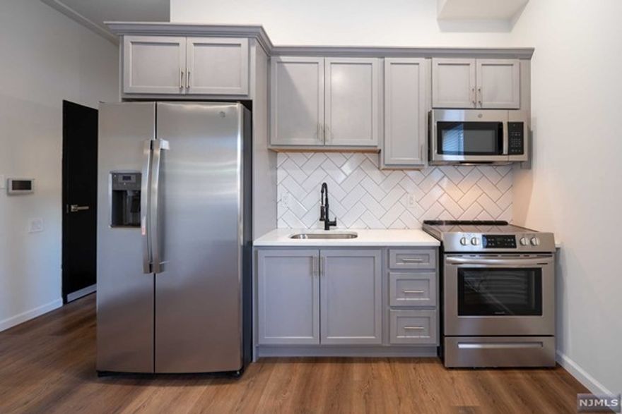 Welcome home to a Spectacular newer construction Studio unit. Plenty of natural light in all rooms will be sure to impress. This unit features an updated kitchen with shaker wood cabinets, stainless steel appliances, quartz counter tops and hard wood floors flowing throughout. Open concept kitchen, living room Bedroom combo will make it easy to entertain guests. Plenty of closets, In unit laundry hookups & touch screen intercom system. Heated and Cooling wall units provided. This first floor unit has elevator access if needed. Bus transportation, Train and Park just a block away, municipal parking close by. One Month Broker fee. Don't miss this Opportunity to occupy this beautiful new unit.